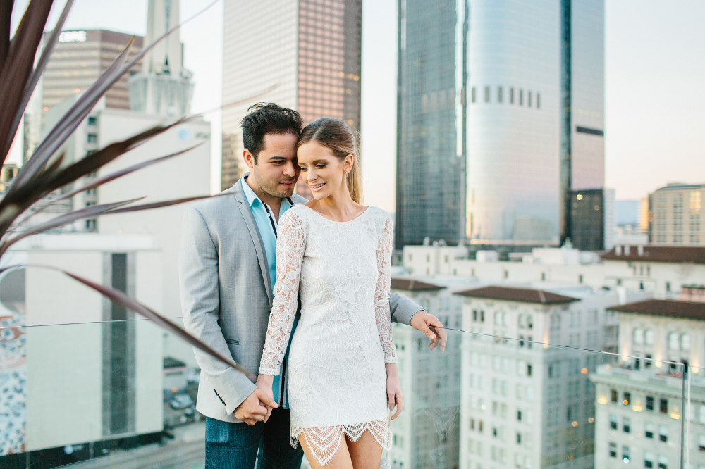 A photo of Ashley and Luis through a plant. 