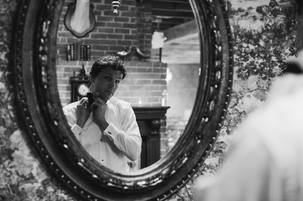 The groom getting dressed. 