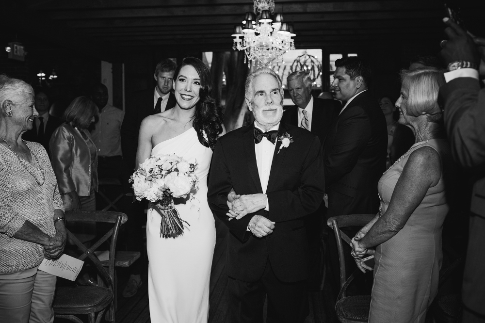 The bride and her dad walking down the aisle. 