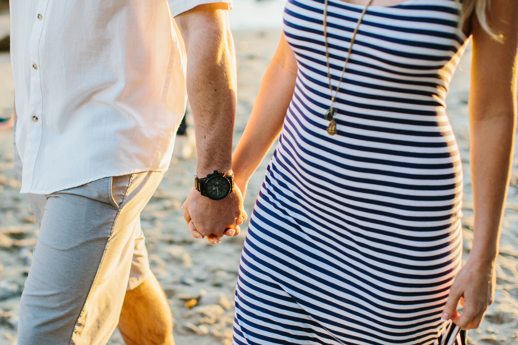 Megan and Travis holding hands. 