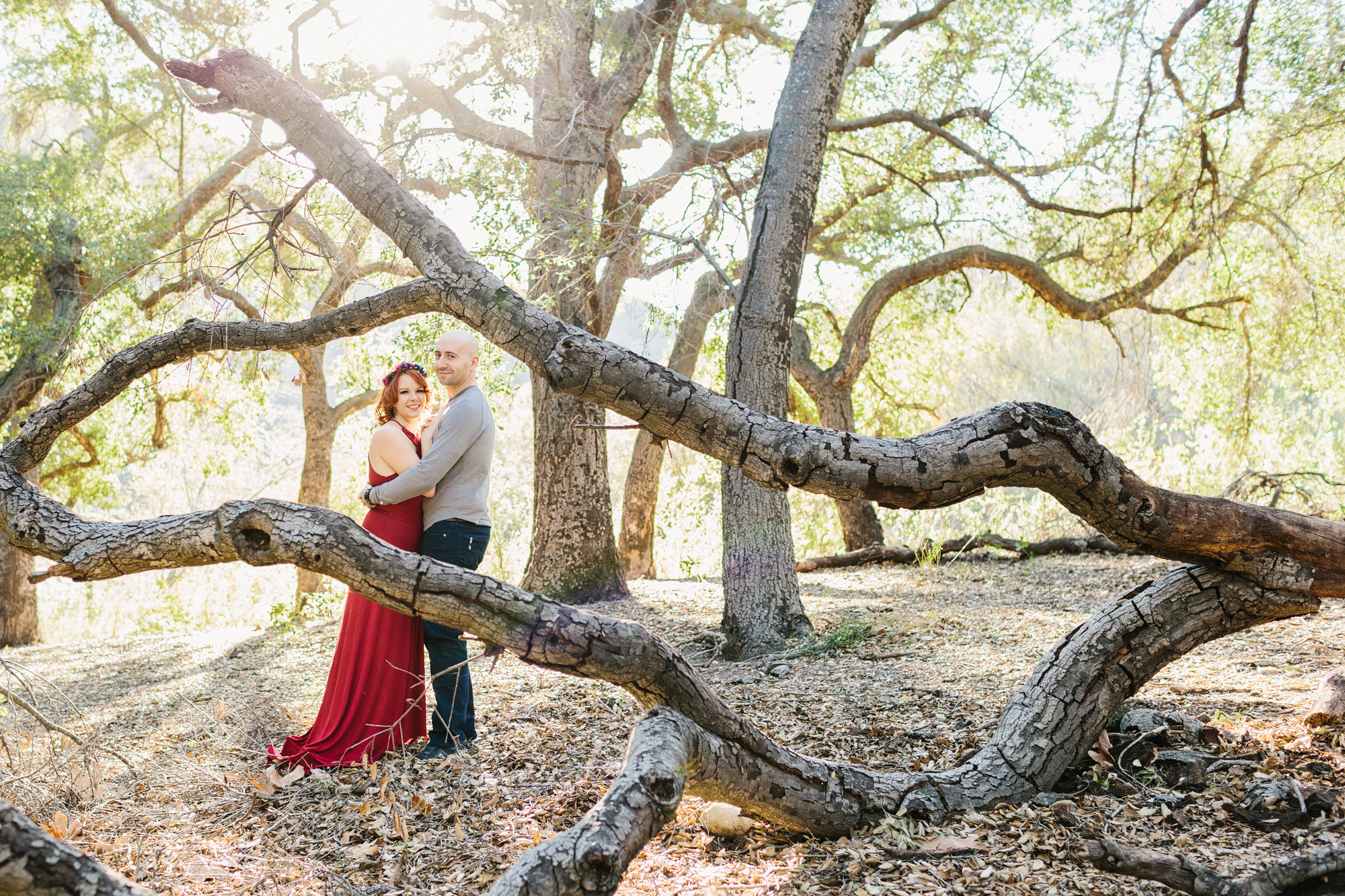 Krystle and Ray behind a tree. 