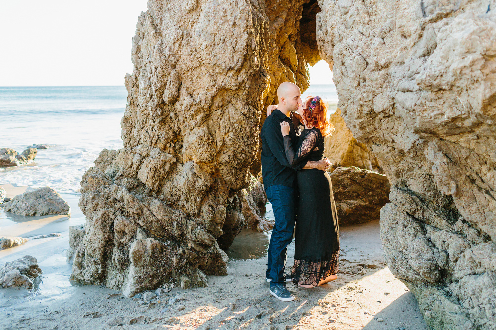 Krystle and Ray under a rock formation. 