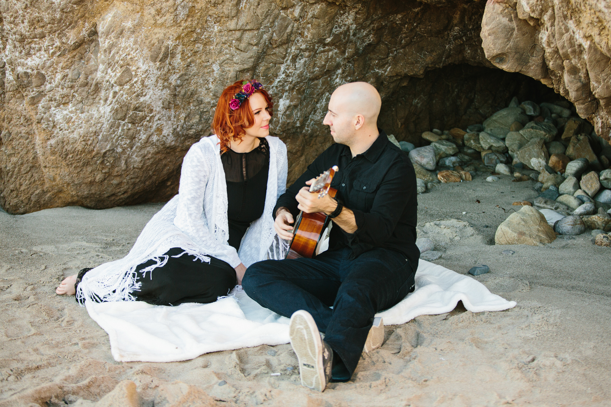 Krystle and Ray on a blanket at the beach. 