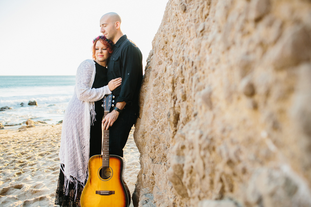 Krystle and Ray against a rock. 