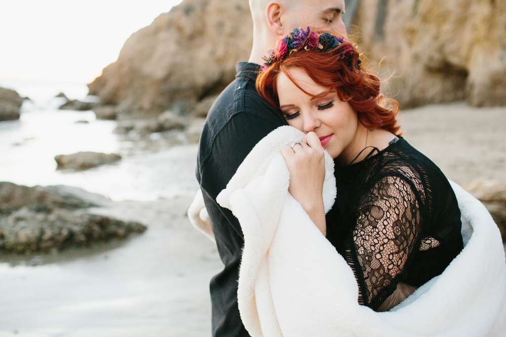 The couple wrapped in a blanket. 