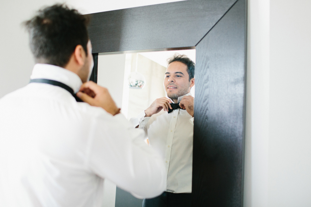 Luis tying his bow tie. 