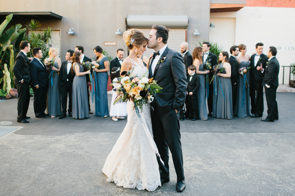 Ashley and Luis in front of the bridal party. 