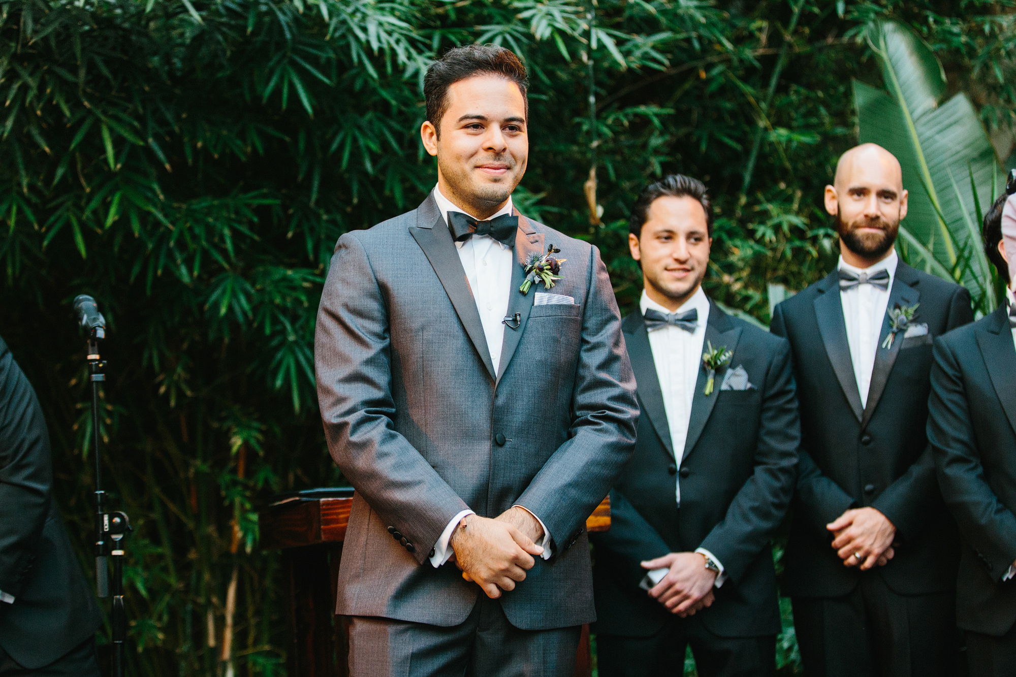 The groom watching the bride walk down the aisle. 