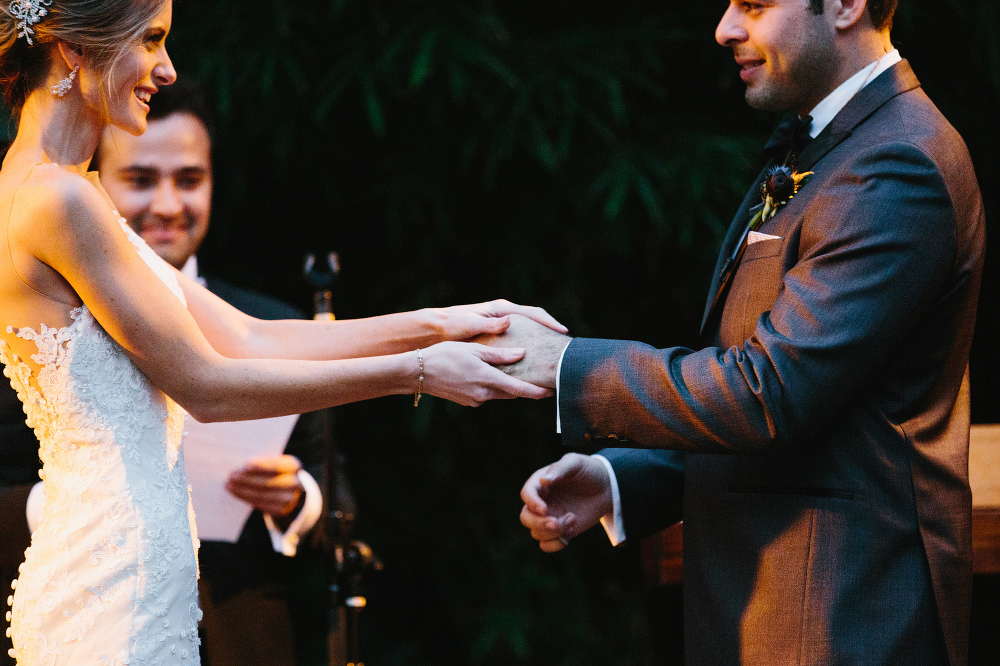 Ashley and Luis exchanging rings. 