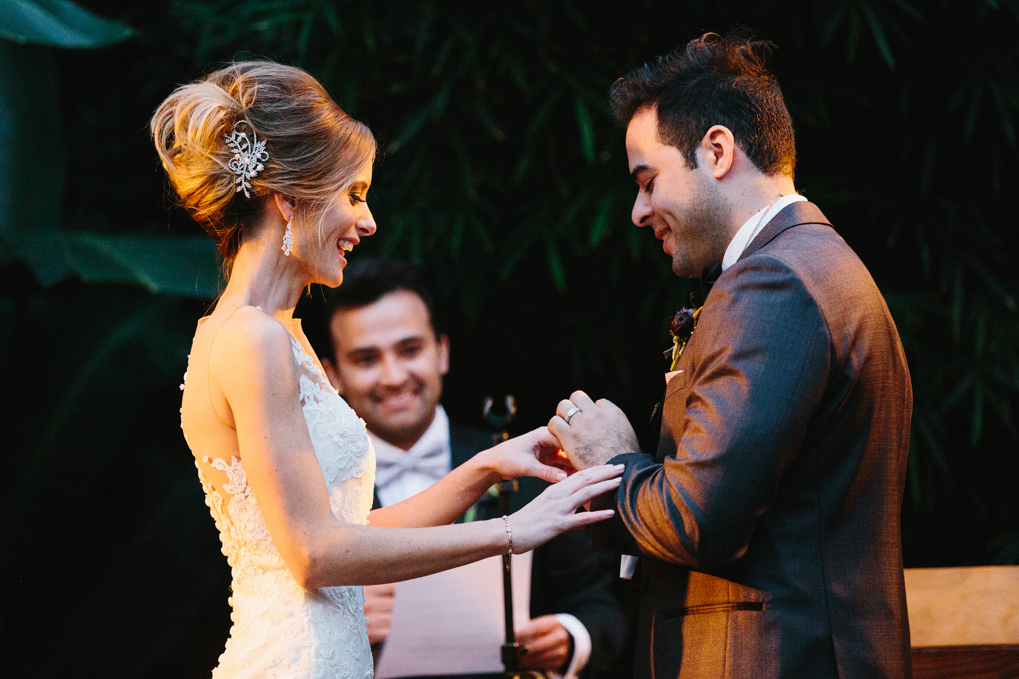 Luis putting on Ashley's ring. 