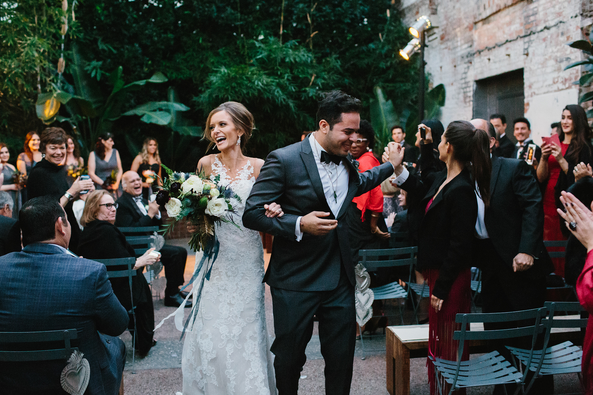 Ashley and Luis walking down the aisle. 