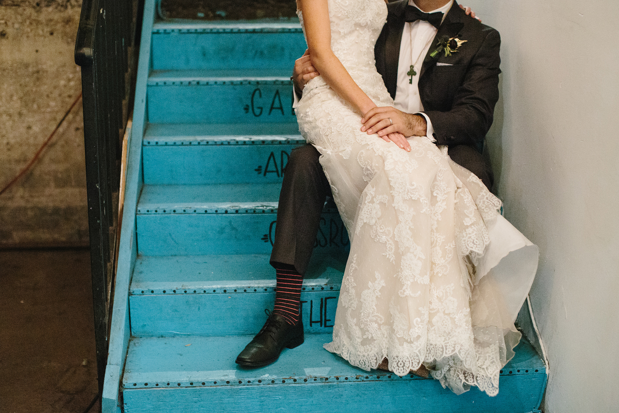 Ashley and Luis sitting on blue stairs. 