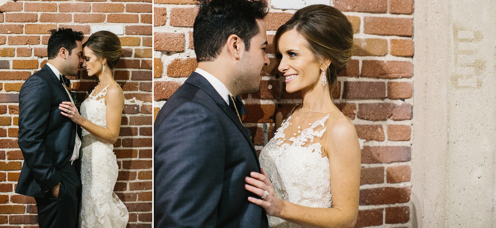 The couple against a brick wall. 