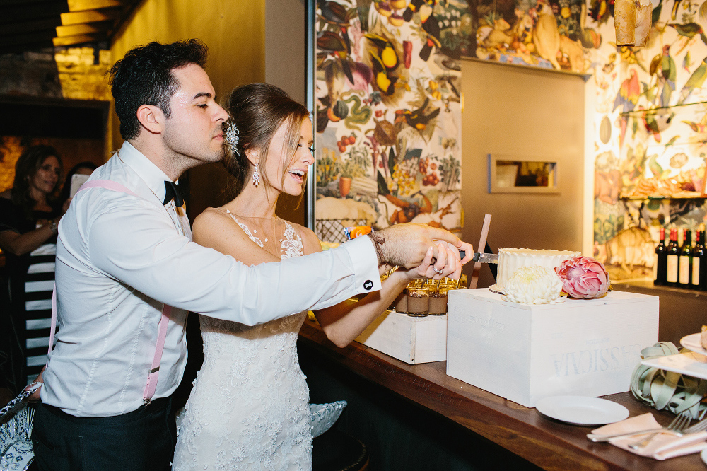 The bride and groom cutting the cake. 