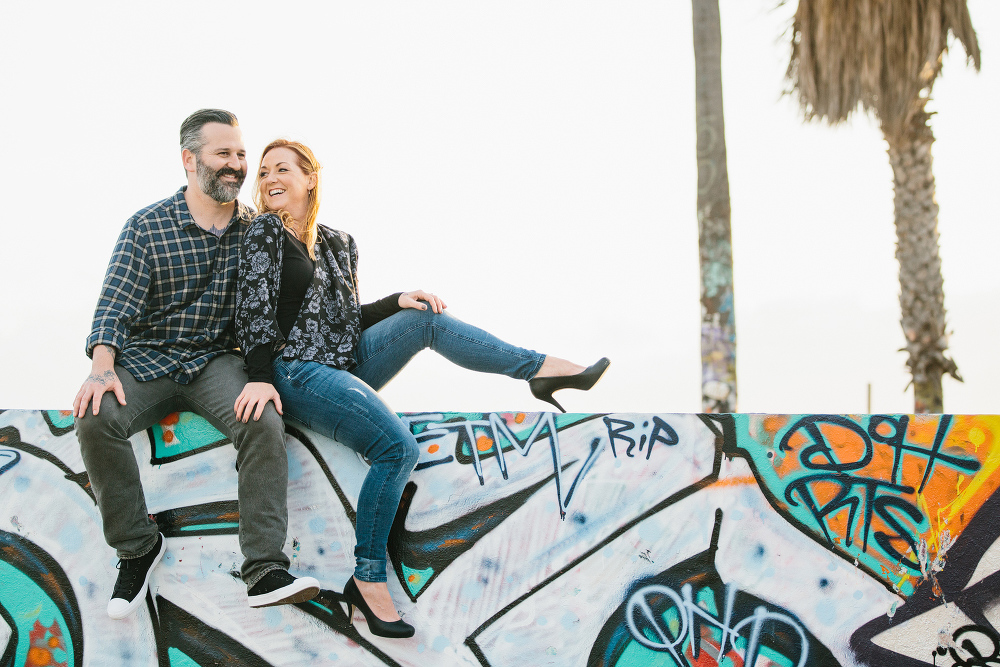 The couple sitting on a wall. 